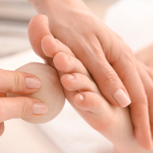 Young woman receiving feet massage in spa salon
