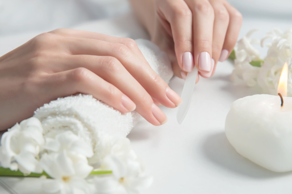 Woman getting nail manicure